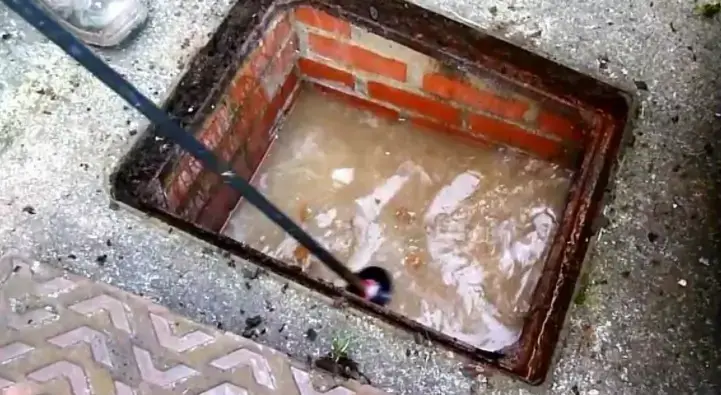 An inspection chamber full of standing waste water: a classic sign of a blockage further down the line.