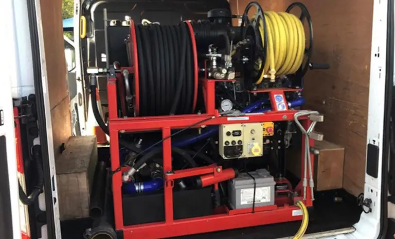 High-pressure drain jetting unit with hose reels fitted inside one of our vans